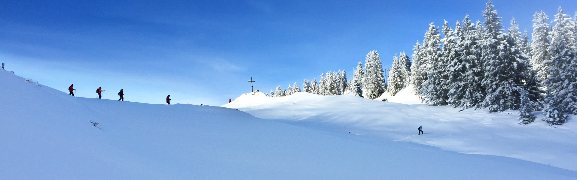Schneeschuhwandern im Allgäu erfreut sich großer Beliebtheit - Das Bild ist von einem Berg im Allgäu aufgenommen und zeigt Schneeschuhwandern Fans